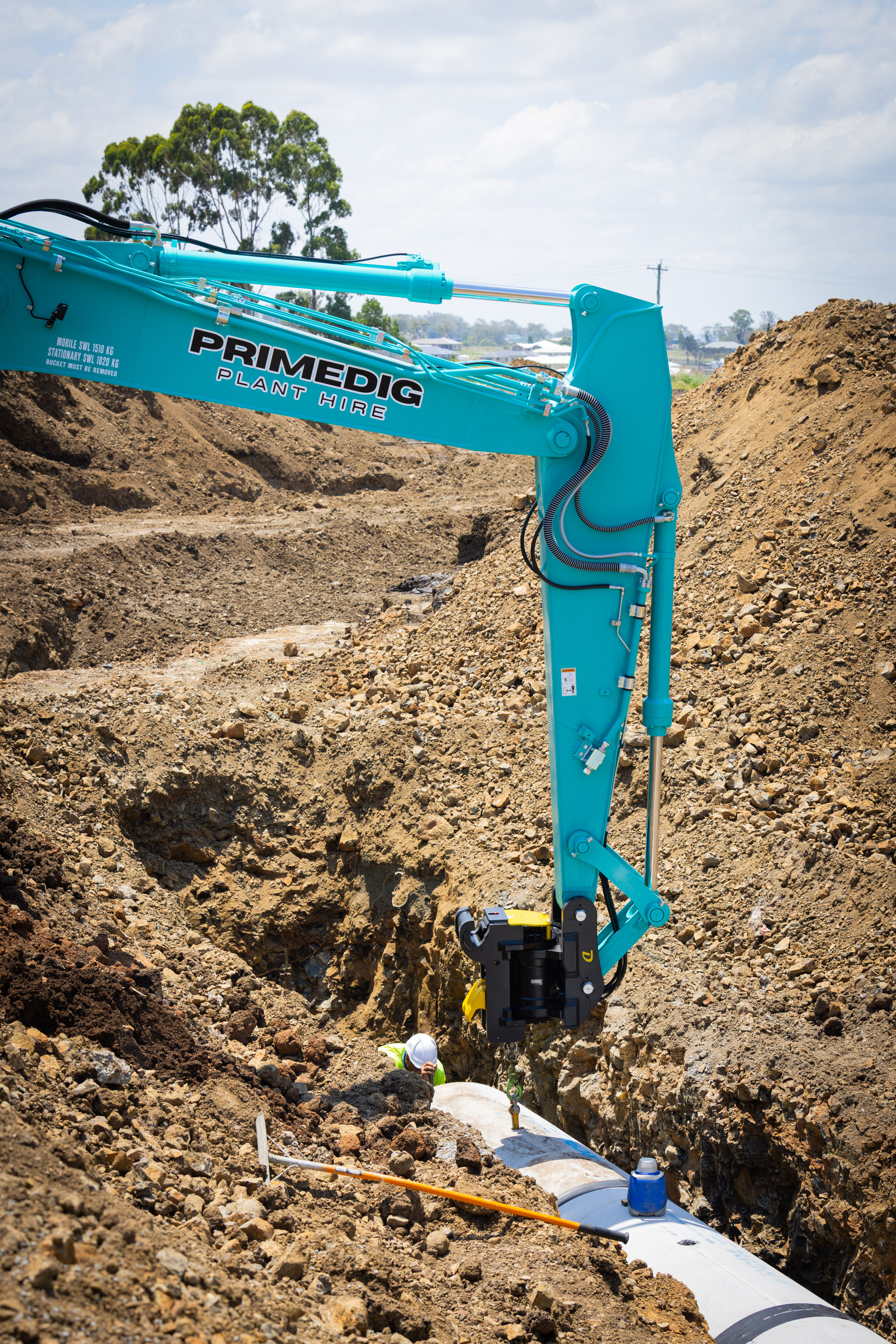 Kobelco excavator digging into a dirt bank on a South East Queensland site